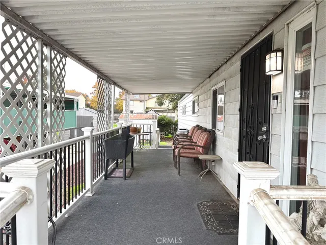 a balcony with chairs and outdoor view