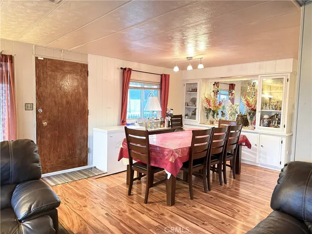 a dining room with furniture a rug and wooden floor