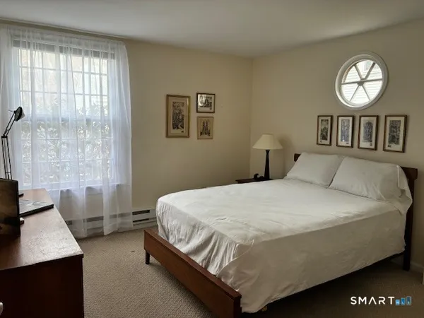 a bed sitting in a bedroom next to a window