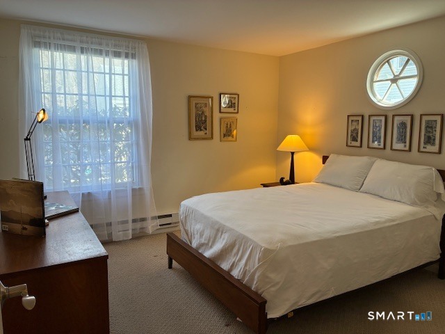 7 River Colony, Unit 7 Guilford, CT 06437 - Photo 13 of 23 a bedroom with a bed and a table