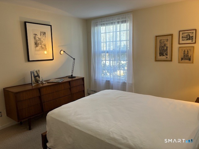 7 River Colony, Unit 7 Guilford, CT 06437 - Photo 14 of 23 a bedroom with a bed and a window