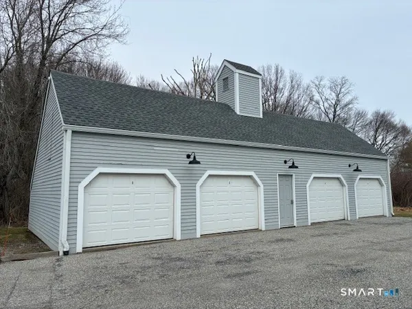 a front view of a house with white garage