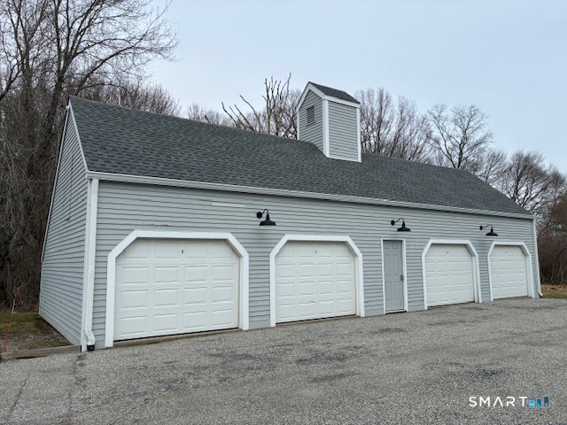 7 River Colony, Unit 7 Guilford, CT 06437 - Photo 20 of 23 a front view of a house with white garage