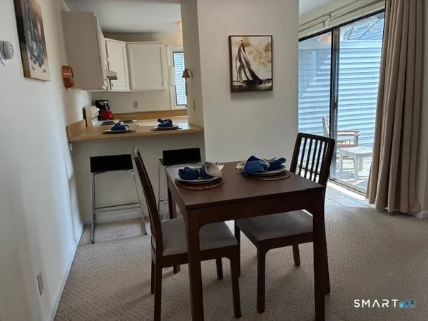 a kitchen with a table chairs and a refrigerator