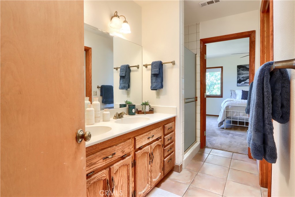 5857 Allred Road Mariposa, CA 95338 - Photo 20 of 62 a en suite bathroom with a sink a mirror and a bathtub