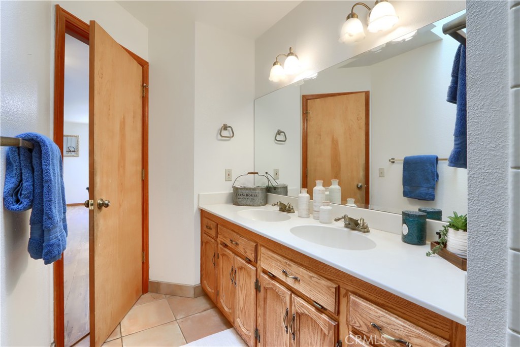5857 Allred Road Mariposa, CA 95338 - Photo 22 of 62 a bathroom with a double vanity sink and a mirror