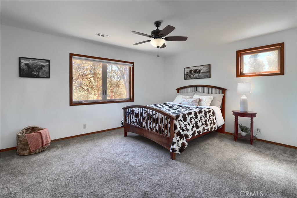 5857 Allred Road Mariposa, CA 95338 - Photo 23 of 62 a bedroom with a bed and a chandelier