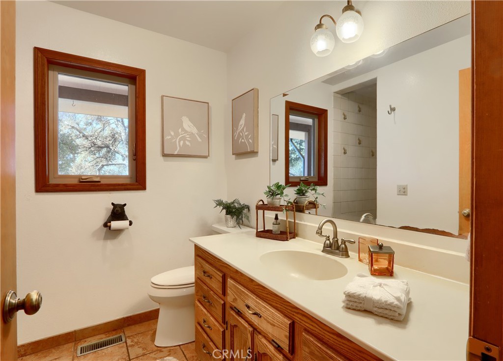 5857 Allred Road Mariposa, CA 95338 - Photo 25 of 62 a bathroom with a granite countertop sink mirror and toilet