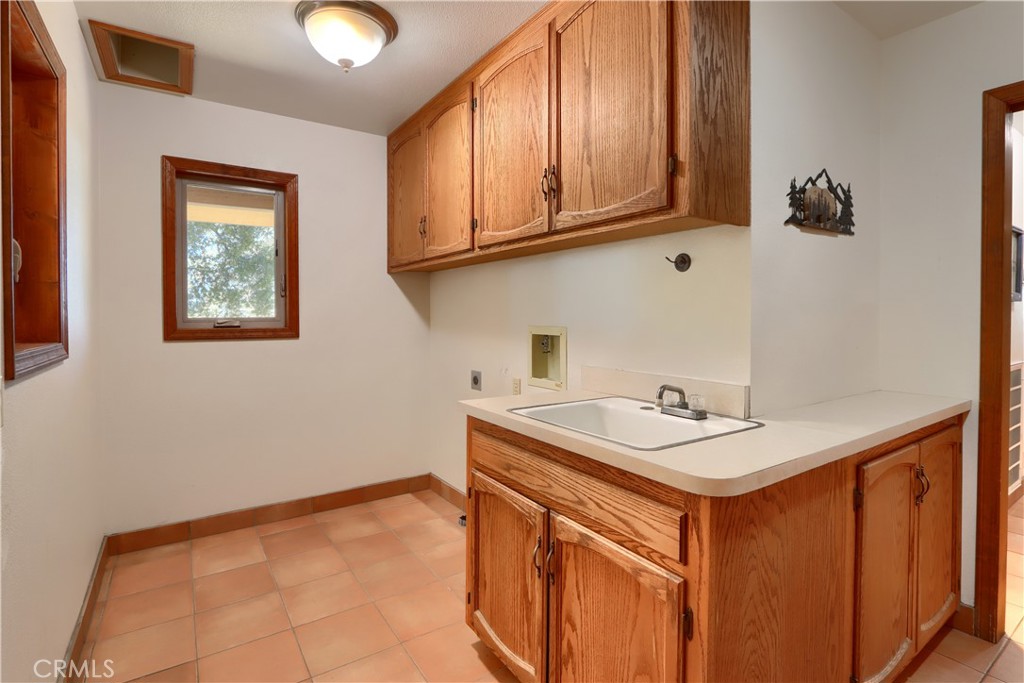 5857 Allred Road Mariposa, CA 95338 - Photo 34 of 62 a utility room with stainless steel appliances granite countertop a sink stove and cabinets