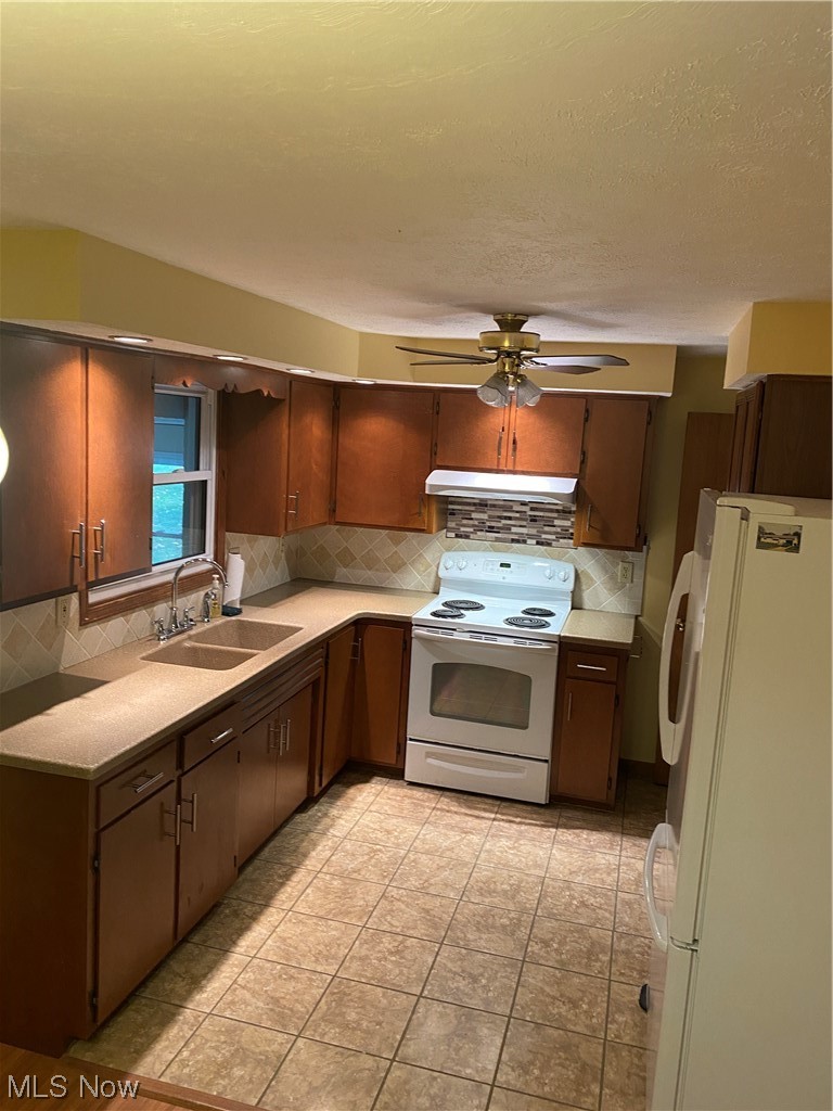 1518 Walnut Road Southwest Massillon, OH 44647 - Photo 2 of 26 Kitchen featuring sink, ceiling fan, white range with electric stovetop, backsplash, and fridge