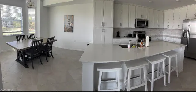 a living room with furniture a flat screen tv and a rug