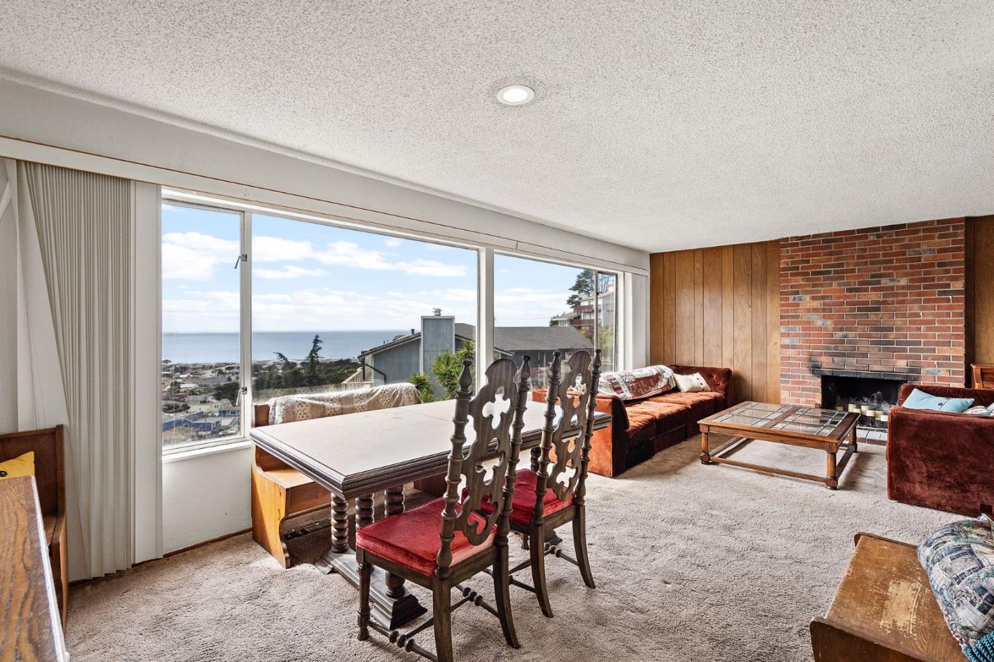 107 Hickey Boulevard Pacifica, CA 94044 - Photo 22 of 29 a living room with furniture a rug and a large window