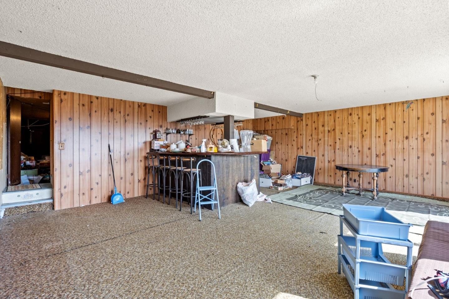 107 Hickey Boulevard Pacifica, CA 94044 - Photo 23 of 29 a living room filled with furniture and a chandelier