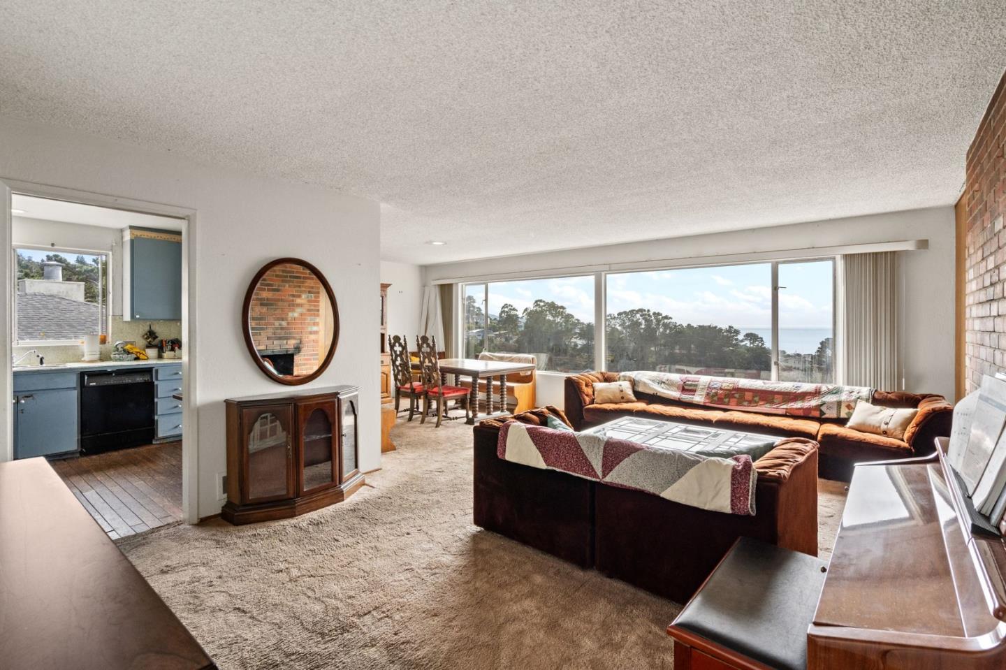 107 Hickey Boulevard Pacifica, CA 94044 - Photo 3 of 29 a living room with furniture a large window and a fireplace