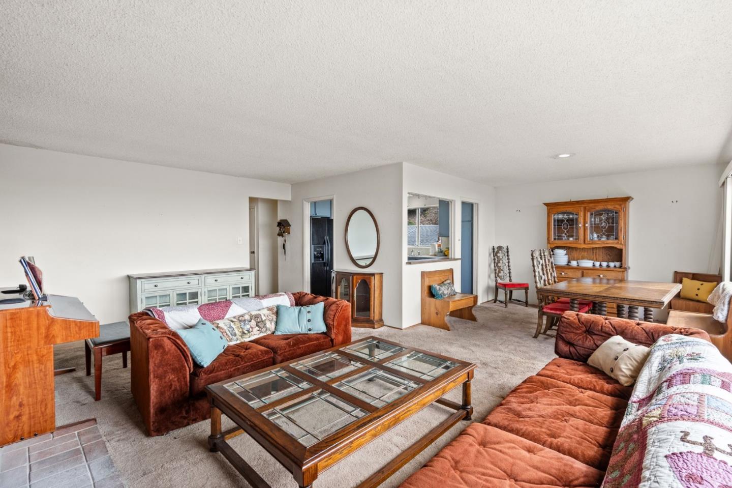 107 Hickey Boulevard Pacifica, CA 94044 - Photo 7 of 29 a living room with furniture a rug and a window
