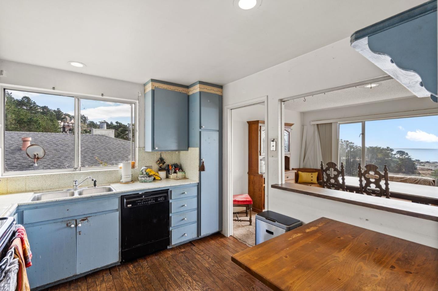 107 Hickey Boulevard Pacifica, CA 94044 - Photo 8 of 29 a room with a wooden floor and large windows