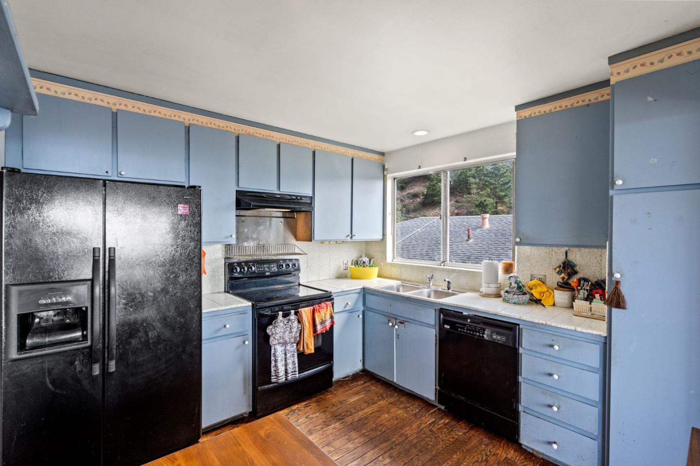 107 Hickey Boulevard Pacifica, CA 94044 - Photo 9 of 29 a kitchen with stainless steel appliances granite countertop a stove a refrigerator and a sink