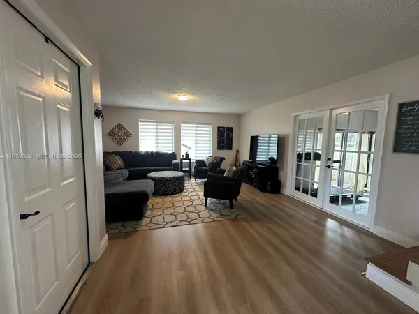 a living room with furniture window and wooden floor