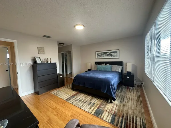 a bedroom with a bed and a television