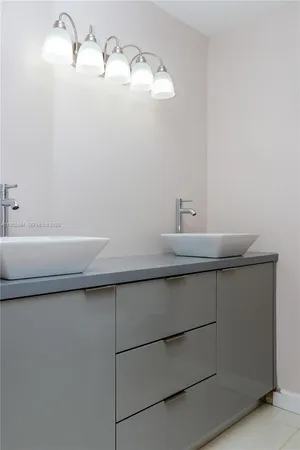 a bedroom with a bed a mirror and a window