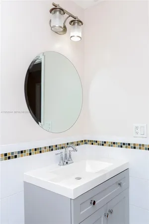 a bathroom with a sink a mirror and a shower