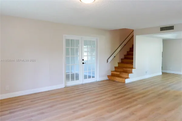 a view of entryway and hall with wooden floor