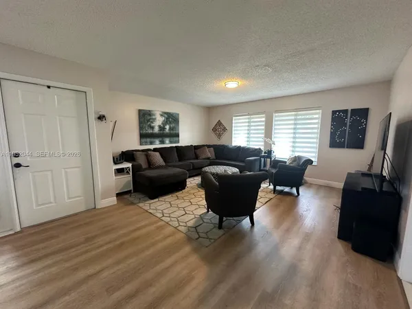 a living room with furniture window and wooden floor