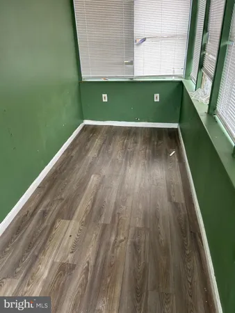 a view of a room with wooden floor