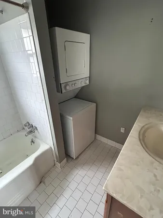 a bathroom with a sink a mirror and bathtub