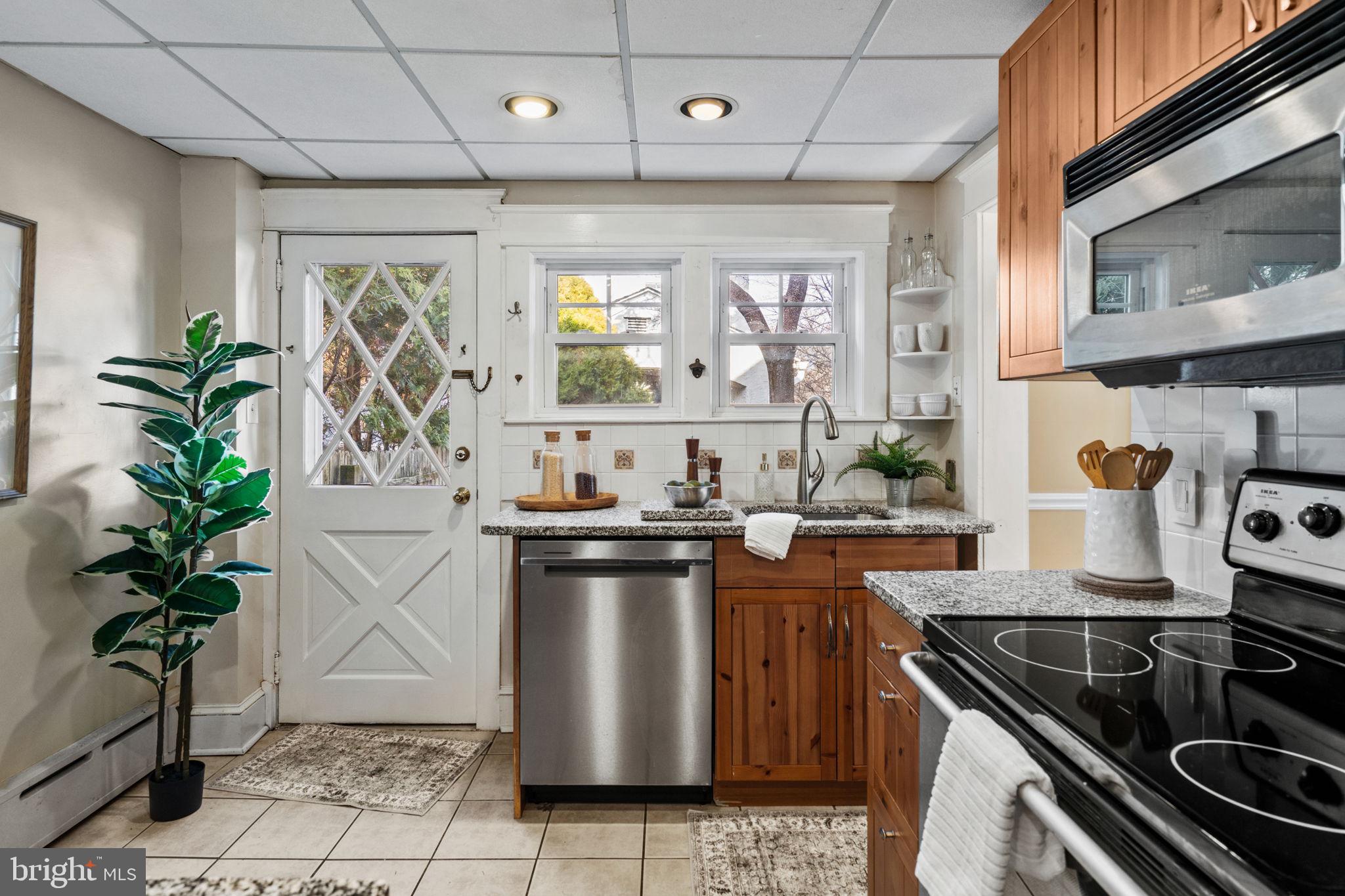 530 East Manoa Road Havertown, PA 19083 - Photo 12 of 32 a kitchen with stainless steel appliances granite countertop a sink a stove and a wooden floors