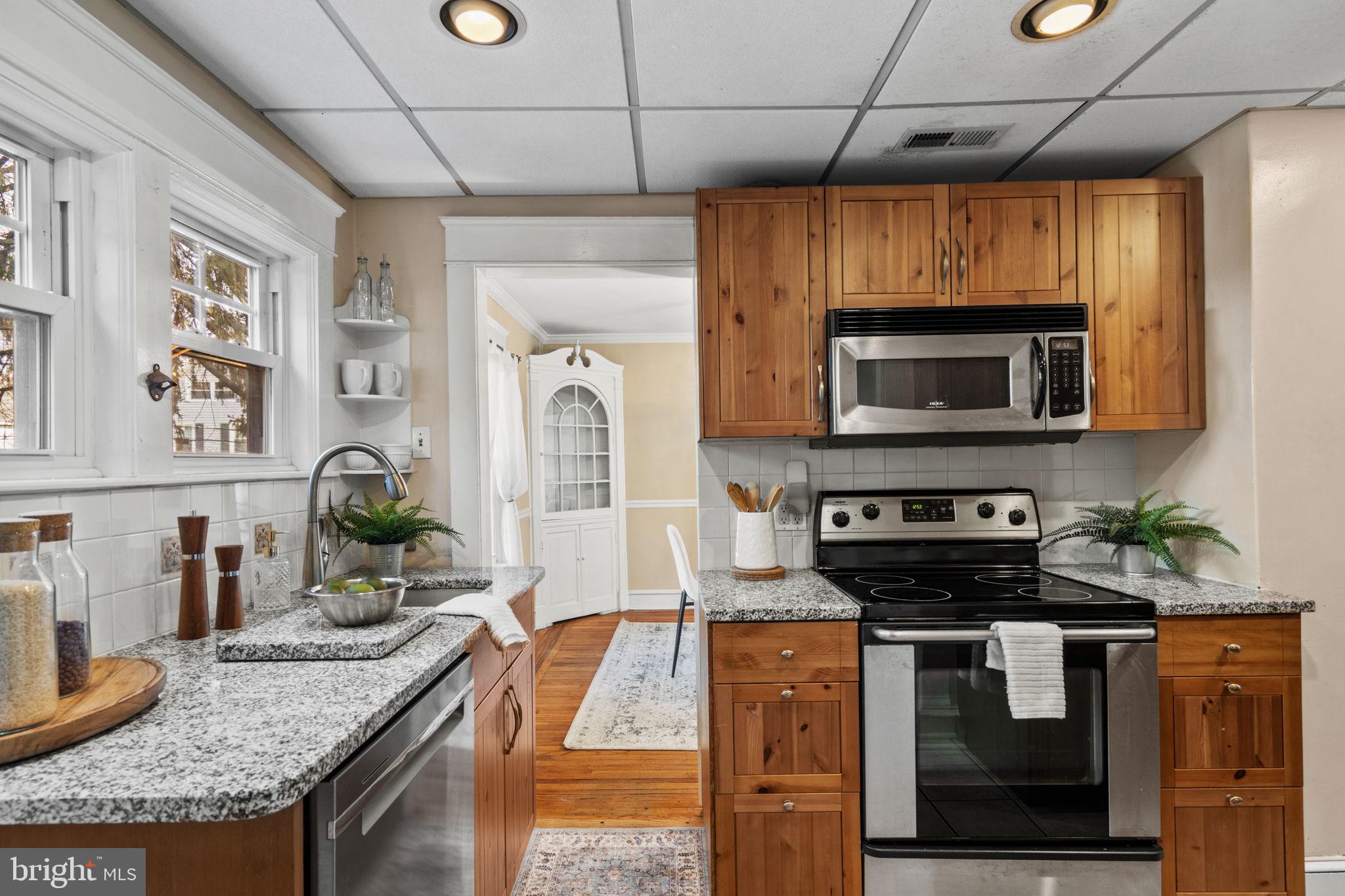 530 East Manoa Road Havertown, PA 19083 - Photo 13 of 32 a kitchen with stainless steel appliances granite countertop a sink a stove top oven a counter space and cabinets