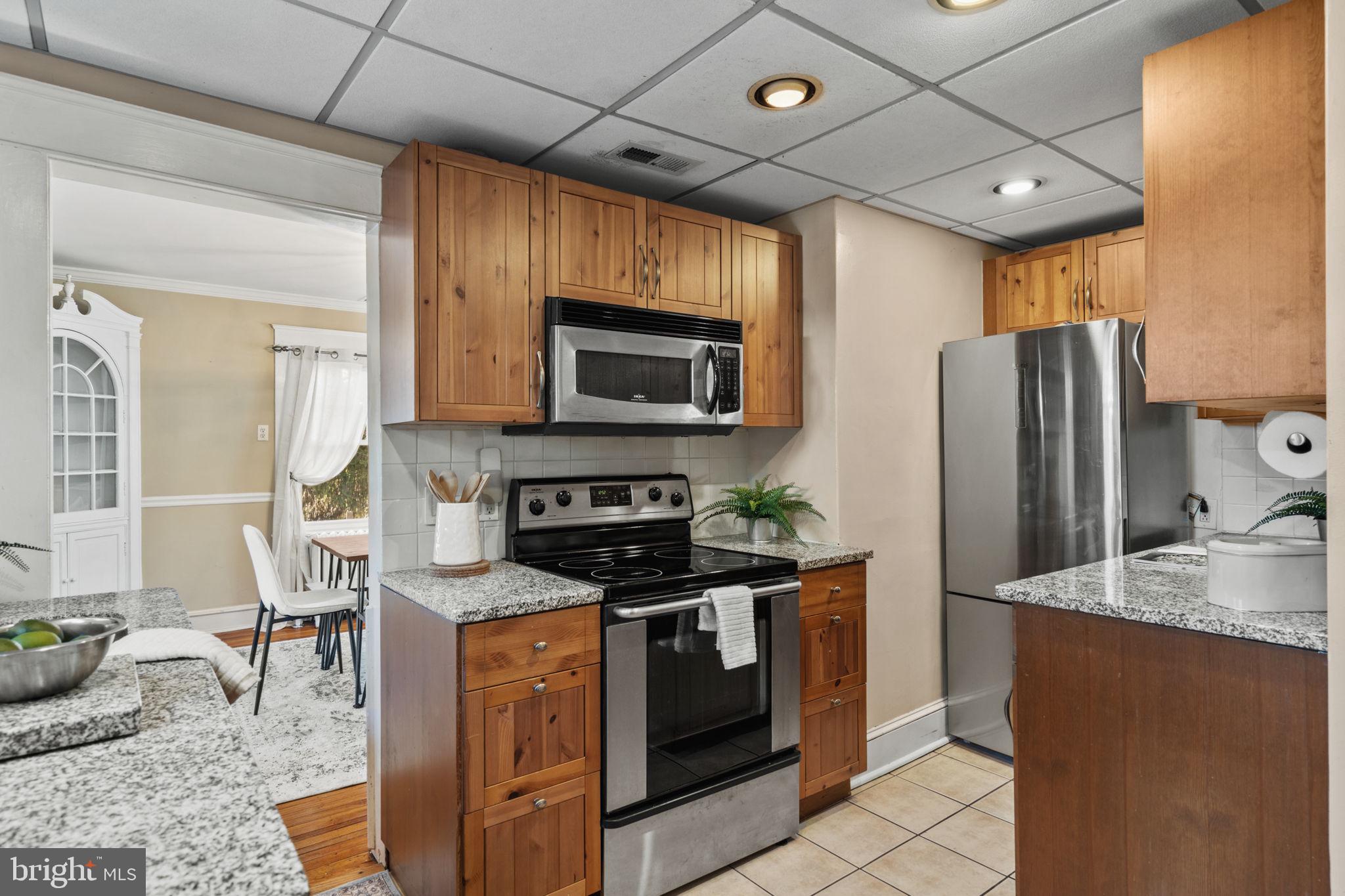 530 East Manoa Road Havertown, PA 19083 - Photo 14 of 32 a kitchen with stainless steel appliances granite countertop a stove refrigerator sink and microwave