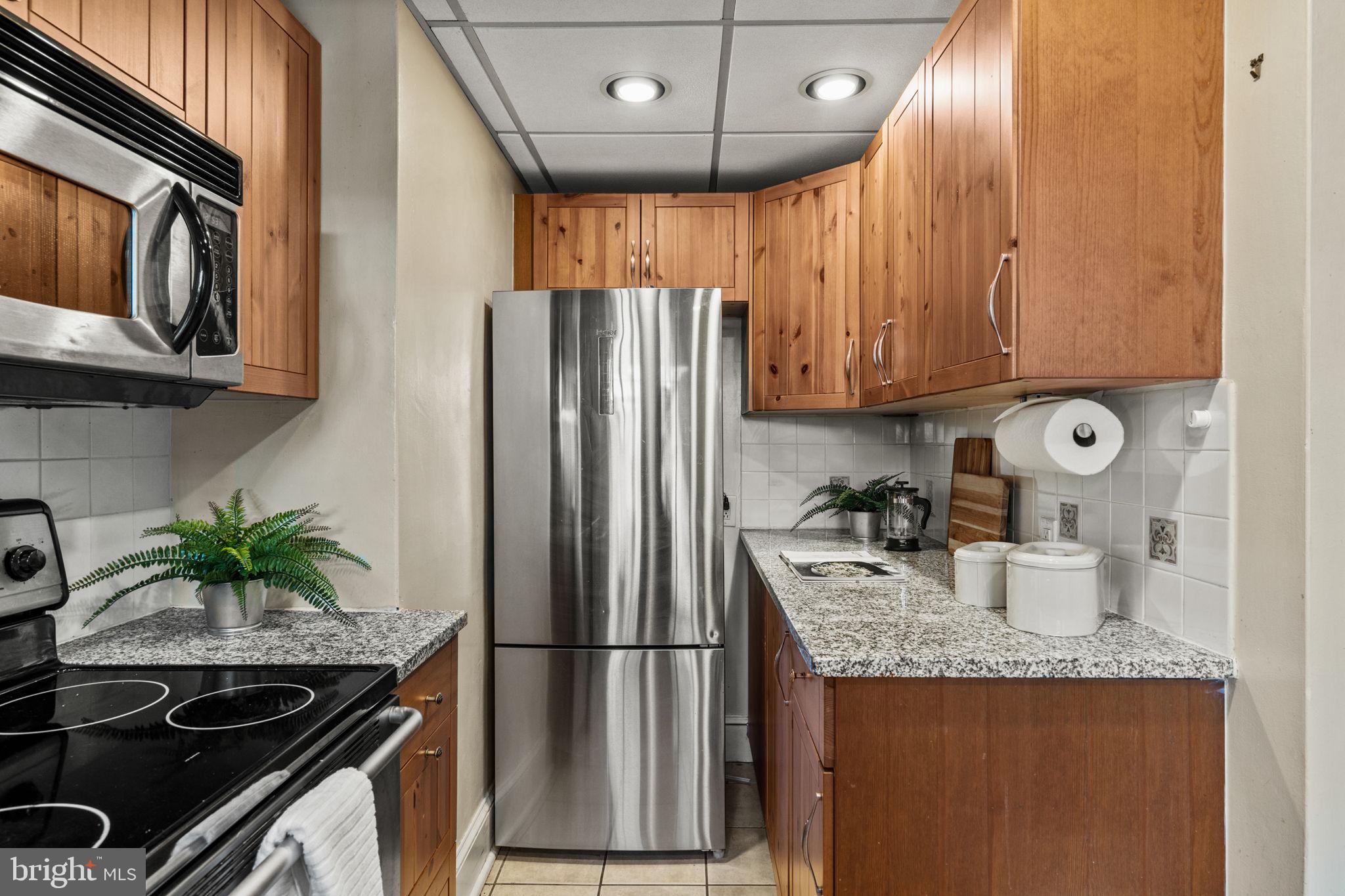 530 East Manoa Road Havertown, PA 19083 - Photo 15 of 32 a kitchen with granite countertop stainless steel appliances a sink stove and refrigerator