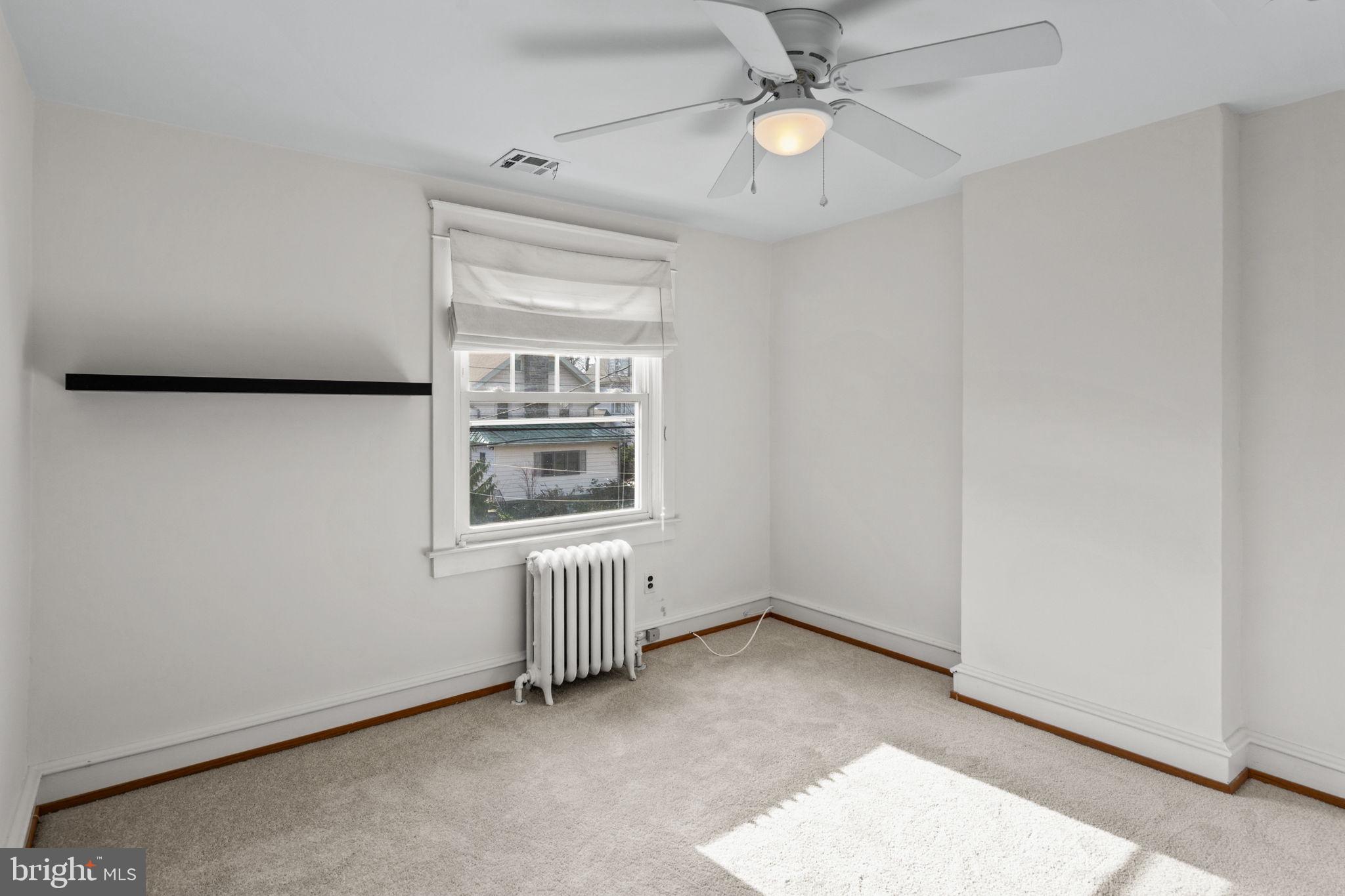 530 East Manoa Road Havertown, PA 19083 - Photo 23 of 32 an empty room with a window and ceiling fan