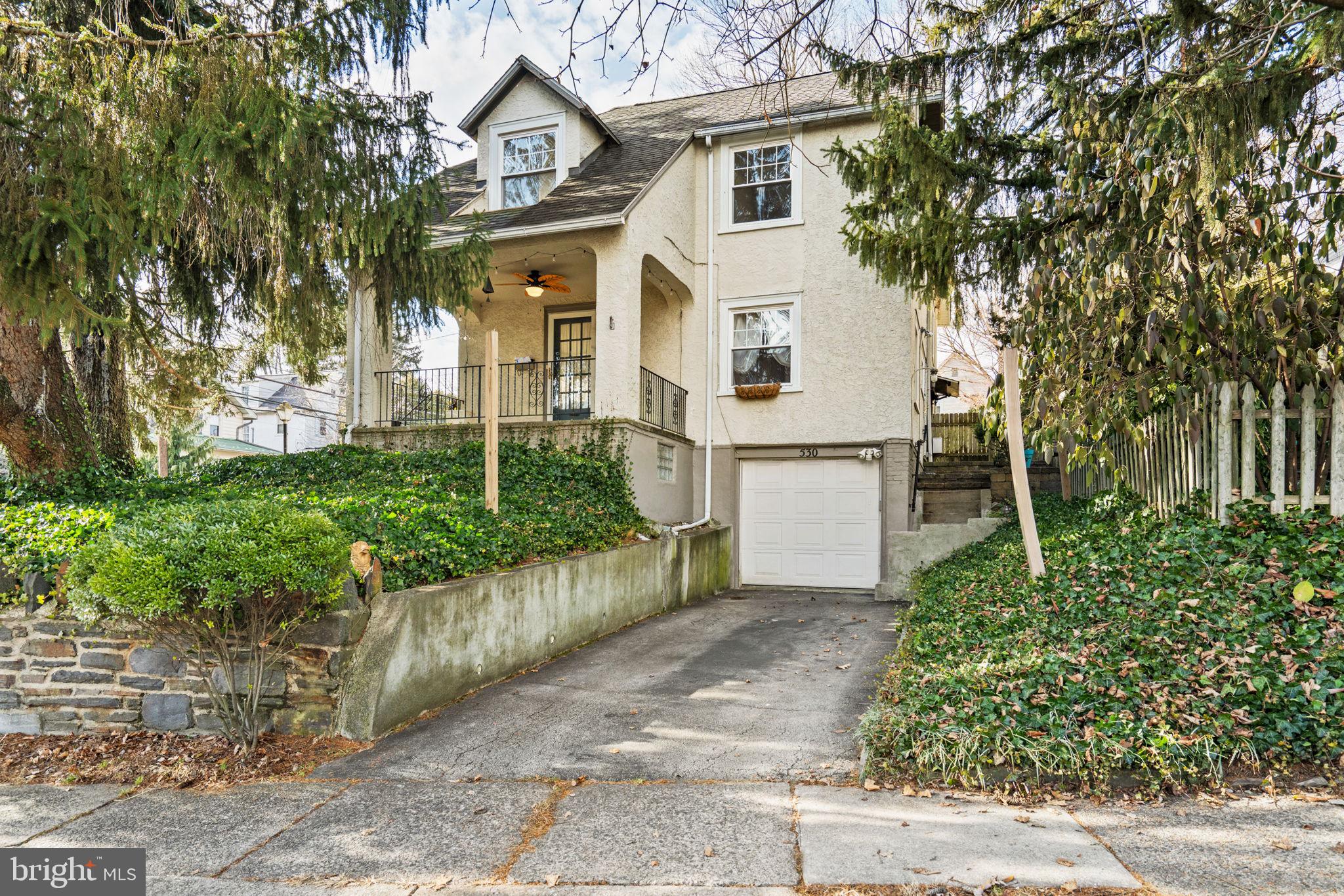 530 East Manoa Road Havertown, PA 19083 - Photo 30 of 32 a view of a white house next to a yard with potted plants