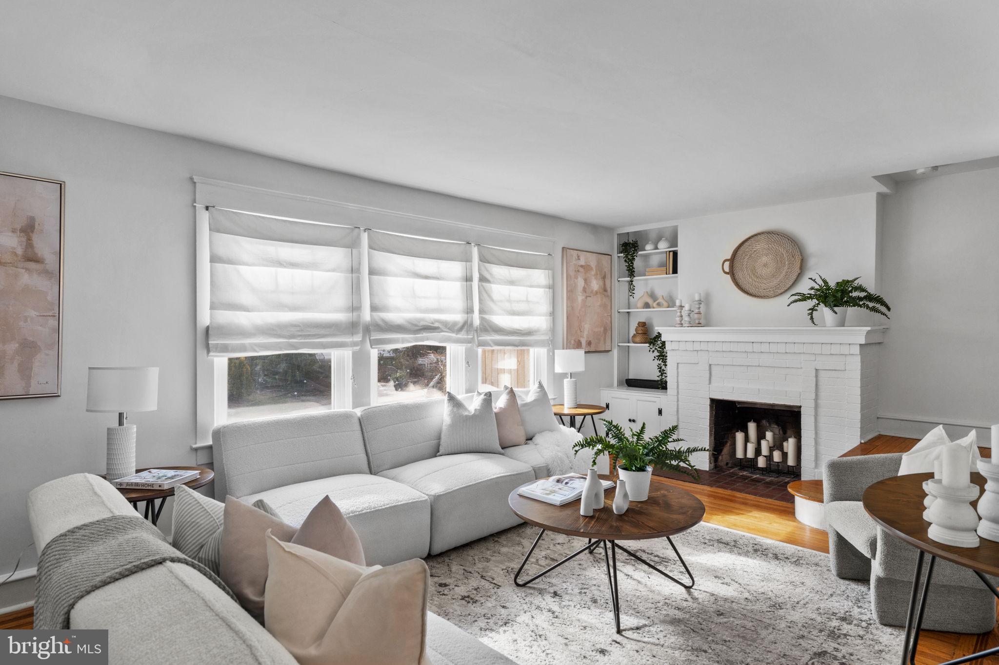 530 East Manoa Road Havertown, PA 19083 - Photo 5 of 32 a living room with furniture a fireplace and a large window