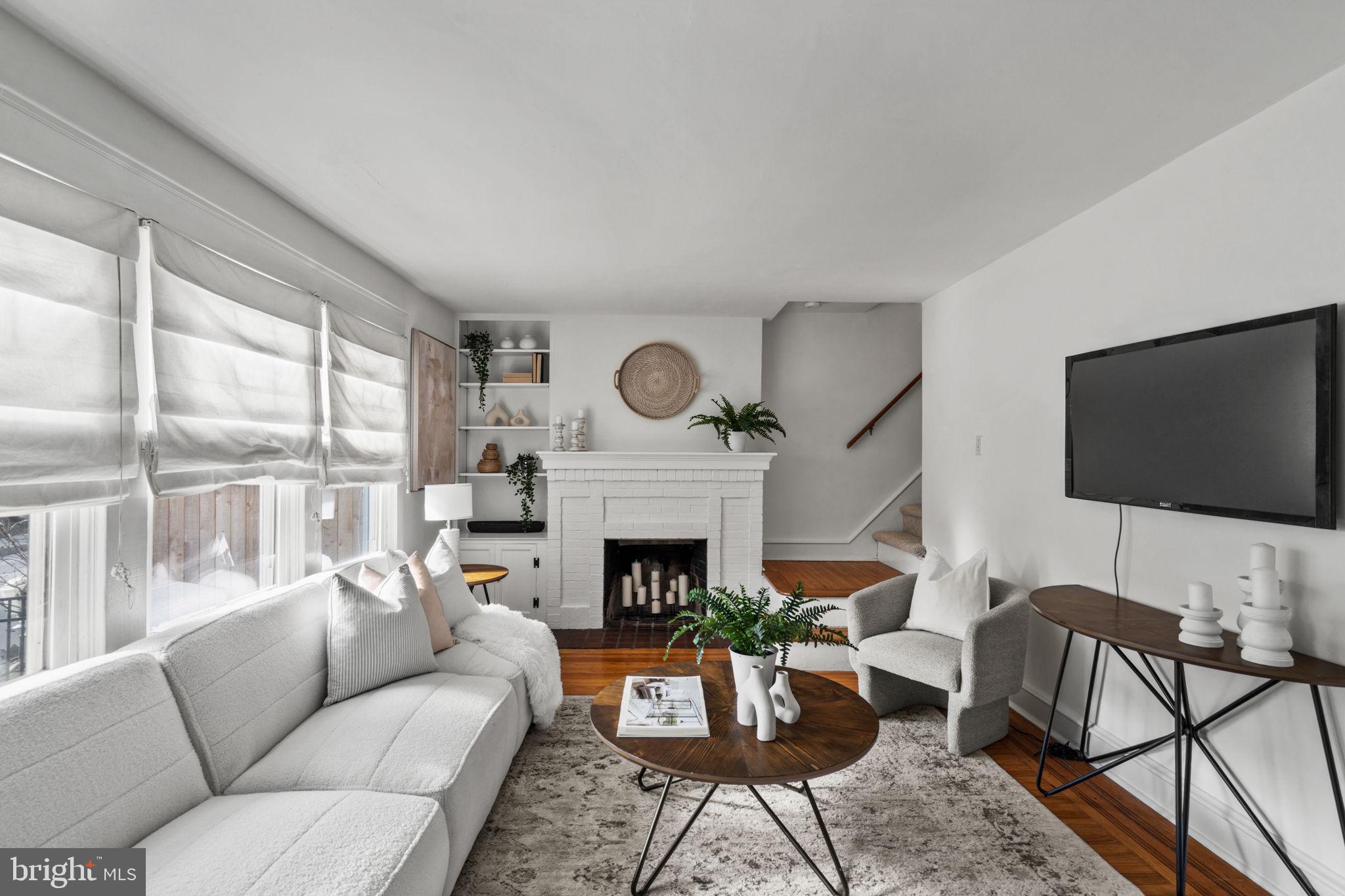 530 East Manoa Road Havertown, PA 19083 - Photo 6 of 32 a living room with furniture a fireplace and a flat screen tv
