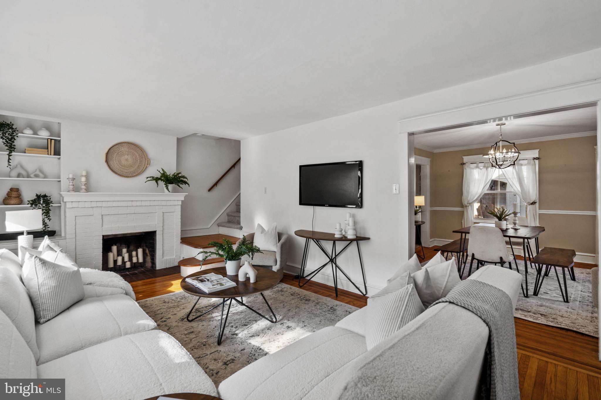 530 East Manoa Road Havertown, PA 19083 - Photo 8 of 32 a living room with furniture a flat screen tv and a fireplace