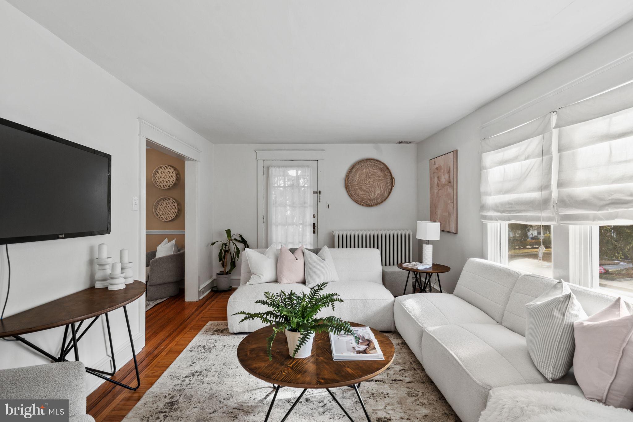 530 East Manoa Road Havertown, PA 19083 - Photo 9 of 32 a living room with furniture a flat screen tv and a large window