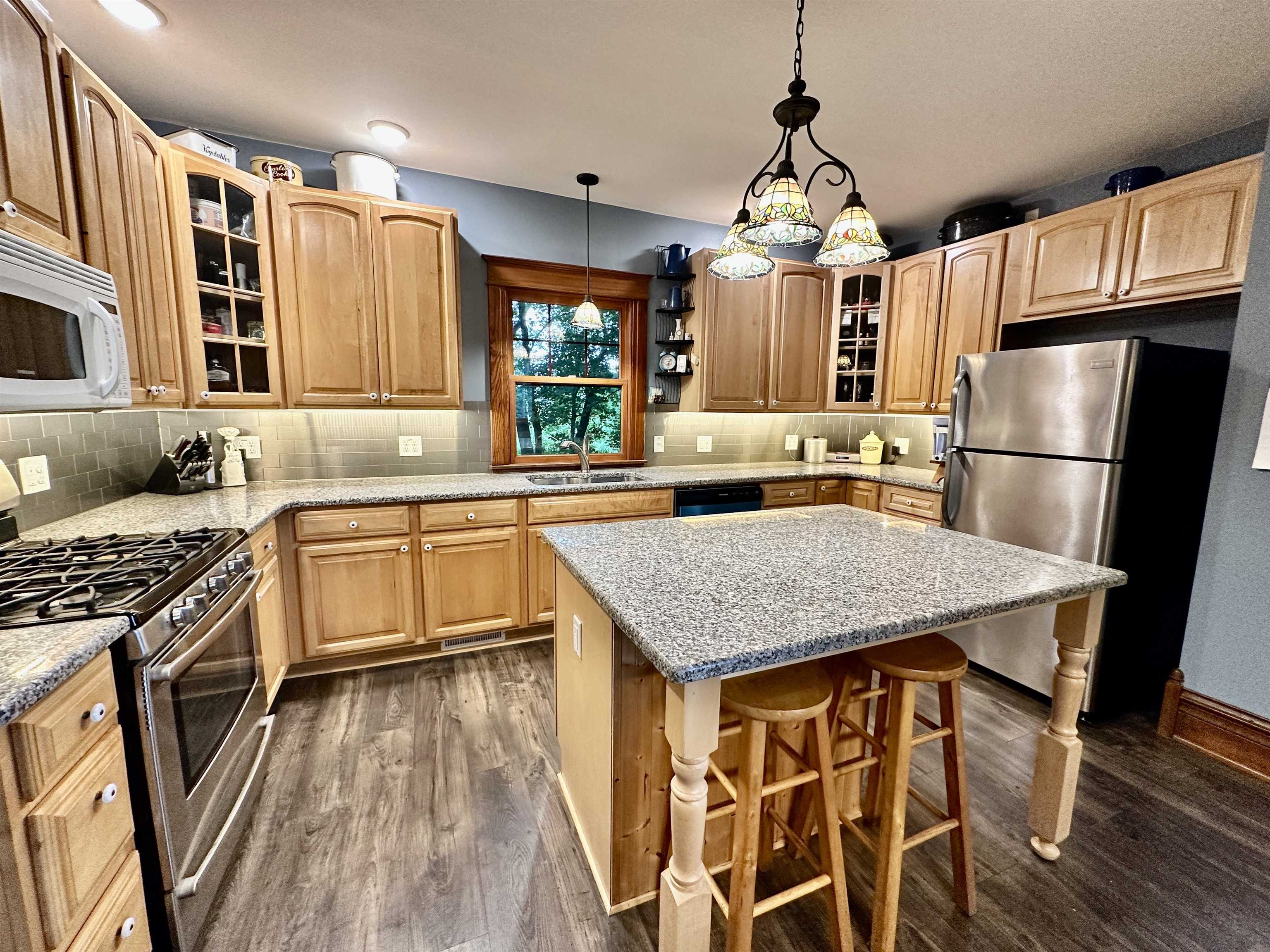 4415 Genoa Road Belvidere, IL 61008 - Photo 16 of 51 a kitchen with stainless steel appliances granite countertop a sink stove and refrigerator