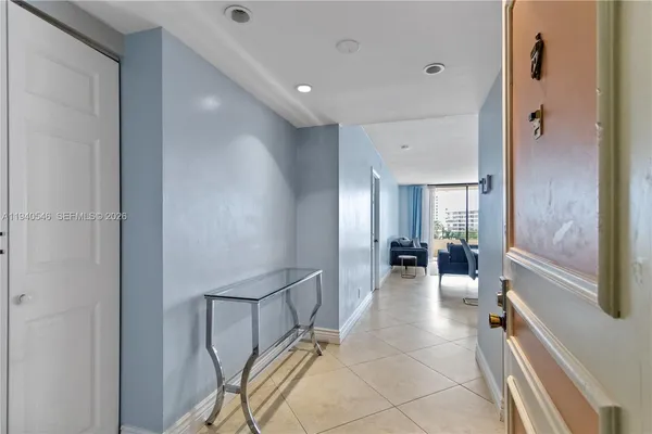 a lobby with furniture and floor to ceiling window