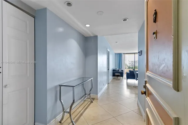 a lobby with furniture and floor to ceiling window