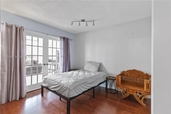 a bedroom with a bed and a chair