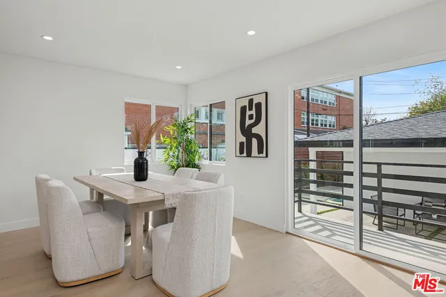 a dining room with furniture and a potted plant