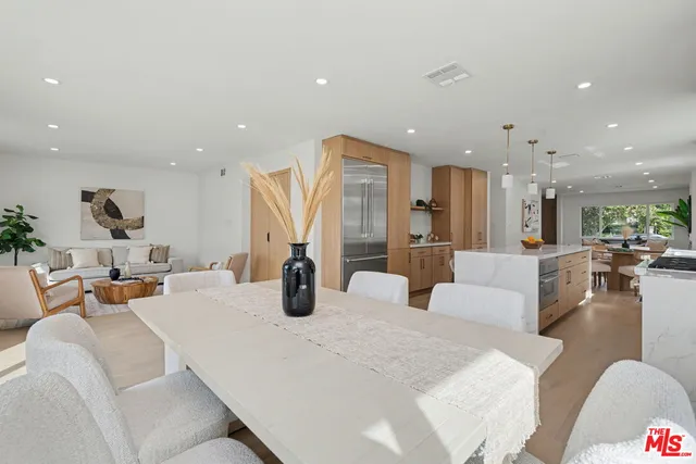 a living room with furniture and a view of kitchen