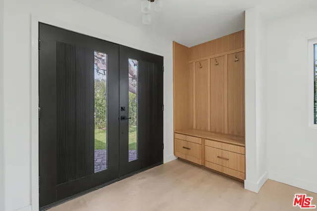 a view of an entryway with wooden floor