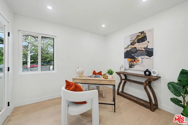 a table and chair in a room with a window