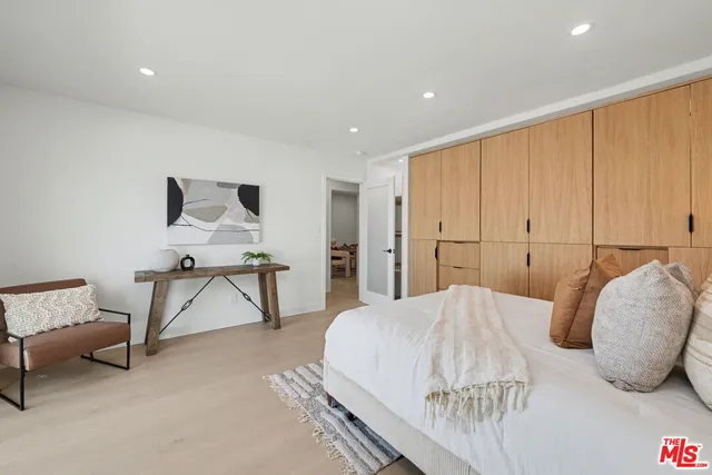 a bedroom with a bed and a chair