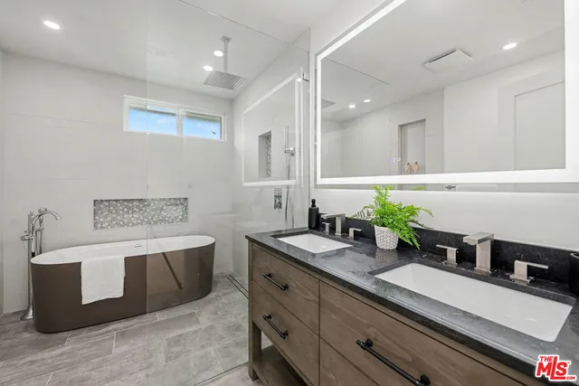 a spacious bathroom with a granite countertop sink