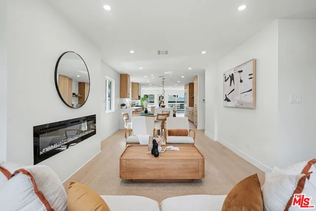 a living room with furniture and a mirror